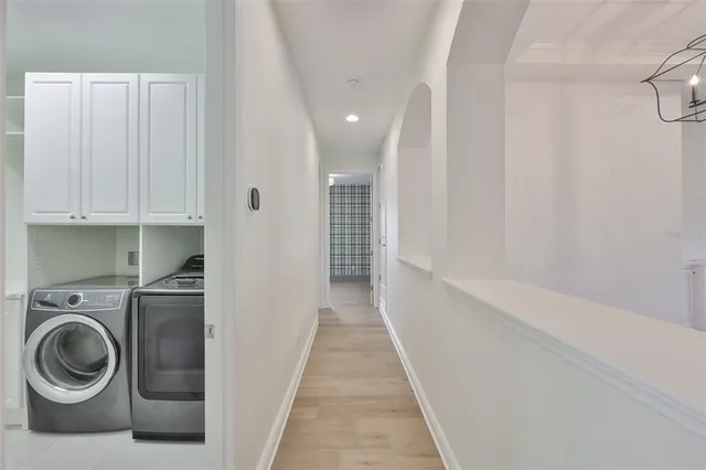 a view of a hallway with washer and dryer