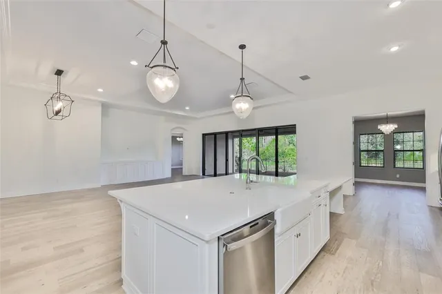 a large kitchen with kitchen island a sink stainless steel appliances and cabinets