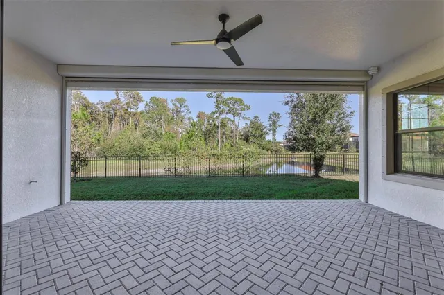 an aerial view of a house with a garden and lake view