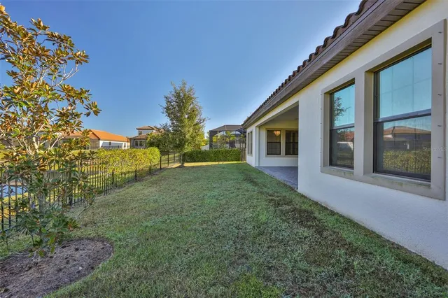 an aerial view of a house with pool lake view and mountain view