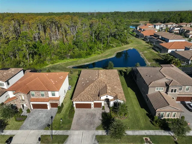 an aerial view of residential houses with outdoor space