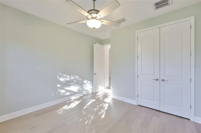 a view of a chandelier fan and fire place