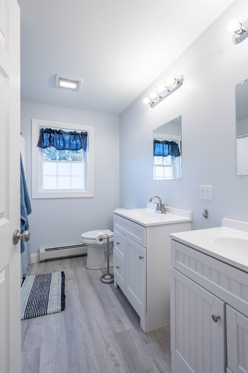 521 Brimfield Road Warren, MA 01083 - Photo 21 of 41 a spacious bathroom with a double vanity sink a mirror and a toilet