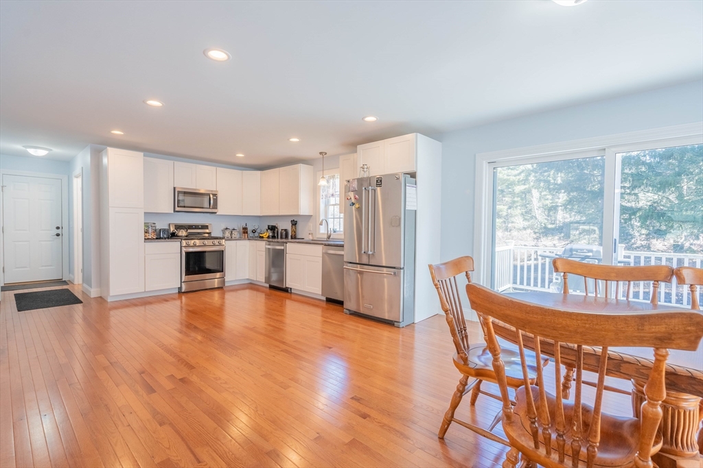 521 Brimfield Road Warren, MA 01083 - Photo 5 of 41 a kitchen with stainless steel appliances granite countertop a dining table chairs refrigerator and sink