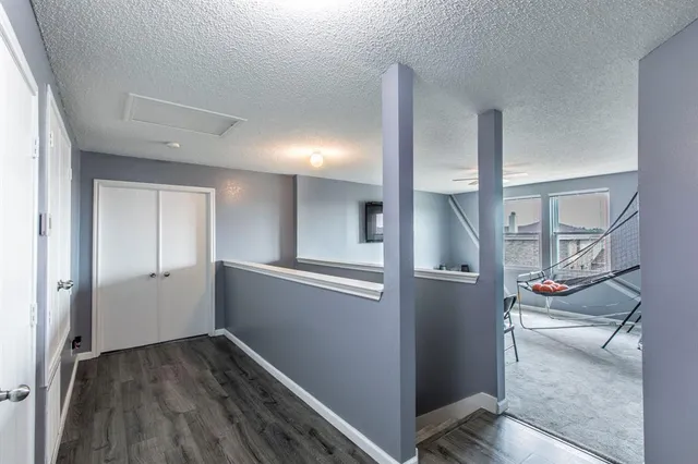 a living room with furniture a flat screen tv and a ceiling fan