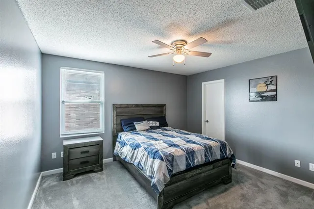 a bathroom with a sink vanity mirror and toilet