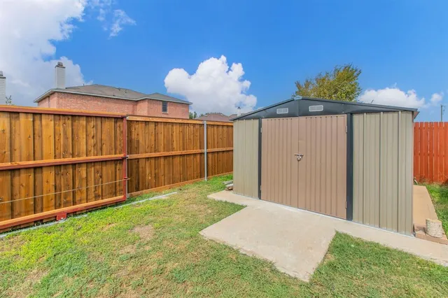 a front view of a house with a yard fire pit and outdoor seating