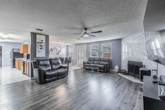 a living room with furniture fireplace and flat screen tv