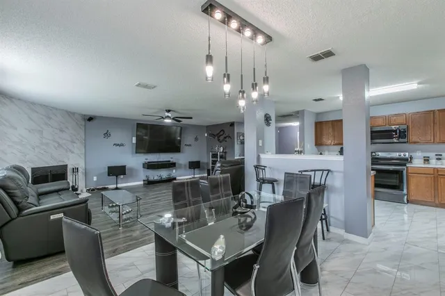 a kitchen with stainless steel appliances a sink stove and cabinets