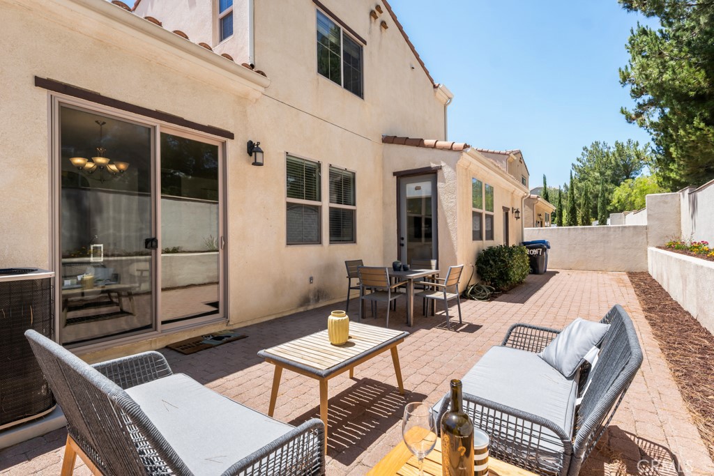20317 Livorno Porter Ranch Porter Ranch, CA 91326 - Photo 25 of 33 a view of a patio with table and chairs with wooden floor and fence