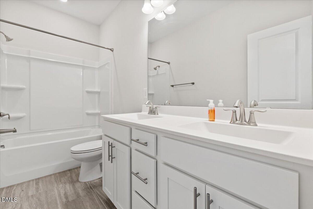 4937 Abundance Avenue Raleigh, NC 27616 - Photo 26 of 36 a bathroom with a sink a toilet and shower