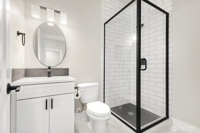 a bathroom with a toilet a sink and a mirror