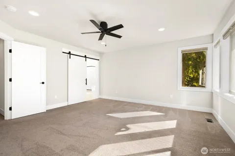 a view of a livingroom with a ceiling fan and window