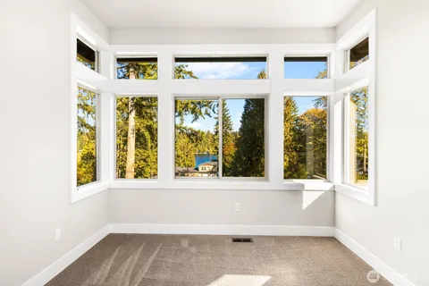 a view of an empty room with large windows