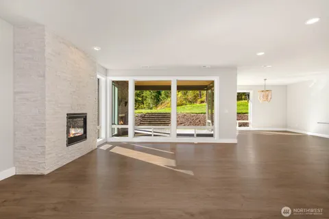 a view of a livingroom with wooden floor and a fireplace