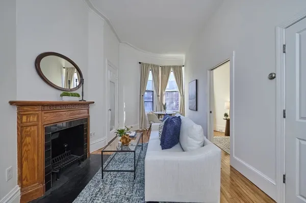 a living room with furniture a window and a fireplace