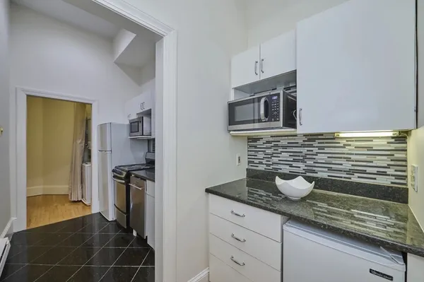 a kitchen with stainless steel appliances a sink stove and refrigerator