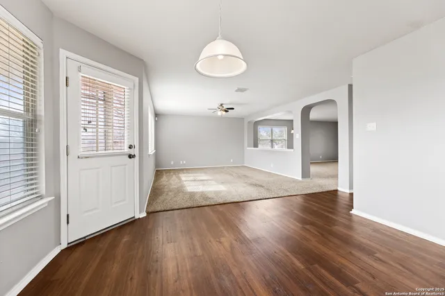 a kitchen with a refrigerator a stove top oven a sink dishwasher and wooden floor