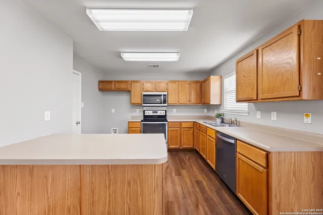 a kitchen with a sink stove and microwave