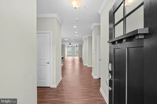 a view of a hallway with wooden floor