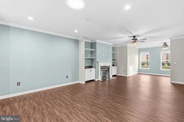 a view of empty room with wooden floor
