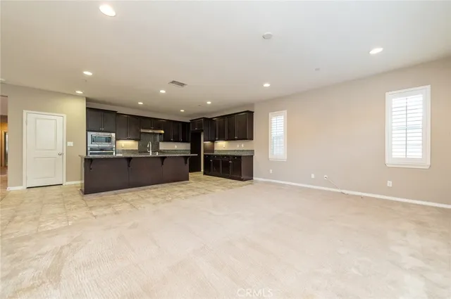 a view of a garden with plants and a bench