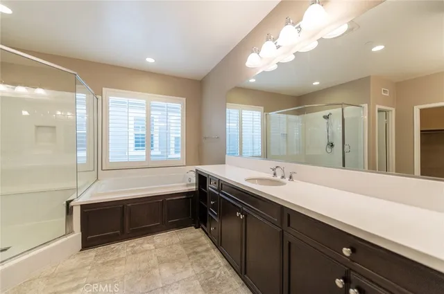 a bathroom with a sink mirror shower and toilet