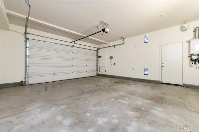 a view of a patio with table and chairs under an umbrella with a small yard