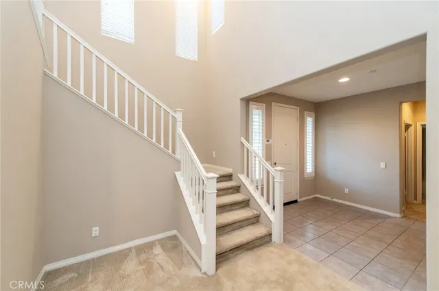a view of staircase with white walls and windows