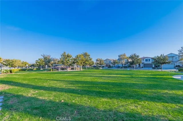 a view of a garden with a building in the background