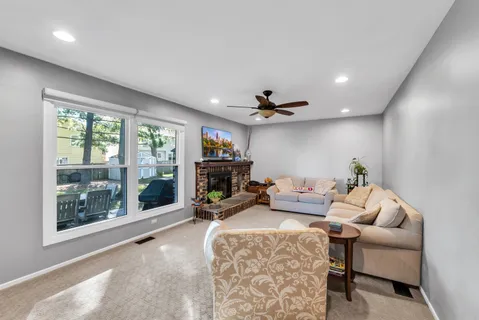a living room with furniture and a fireplace