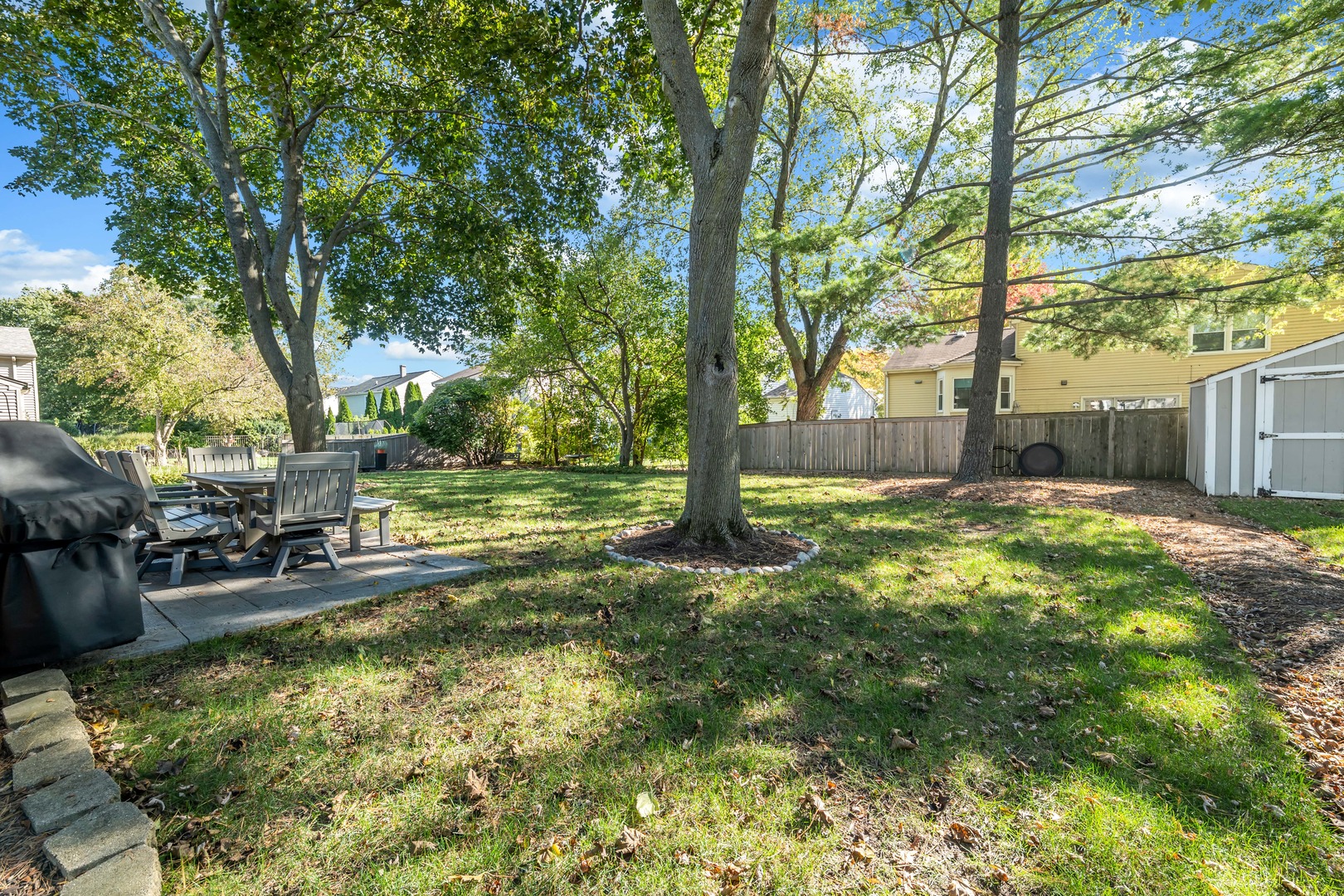 896 Chaucer Way Buffalo Grove, IL 60089 - Photo 25 of 26 a backyard of a house with fountain table and chairs