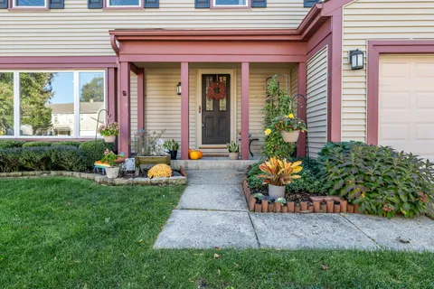 a front view of a house with outdoor seating and plants