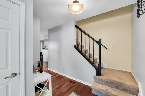 a view of entryway and hall with wooden floor