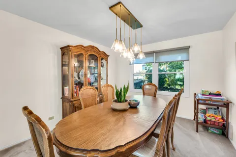 a view of a dining room with furniture window and outside view