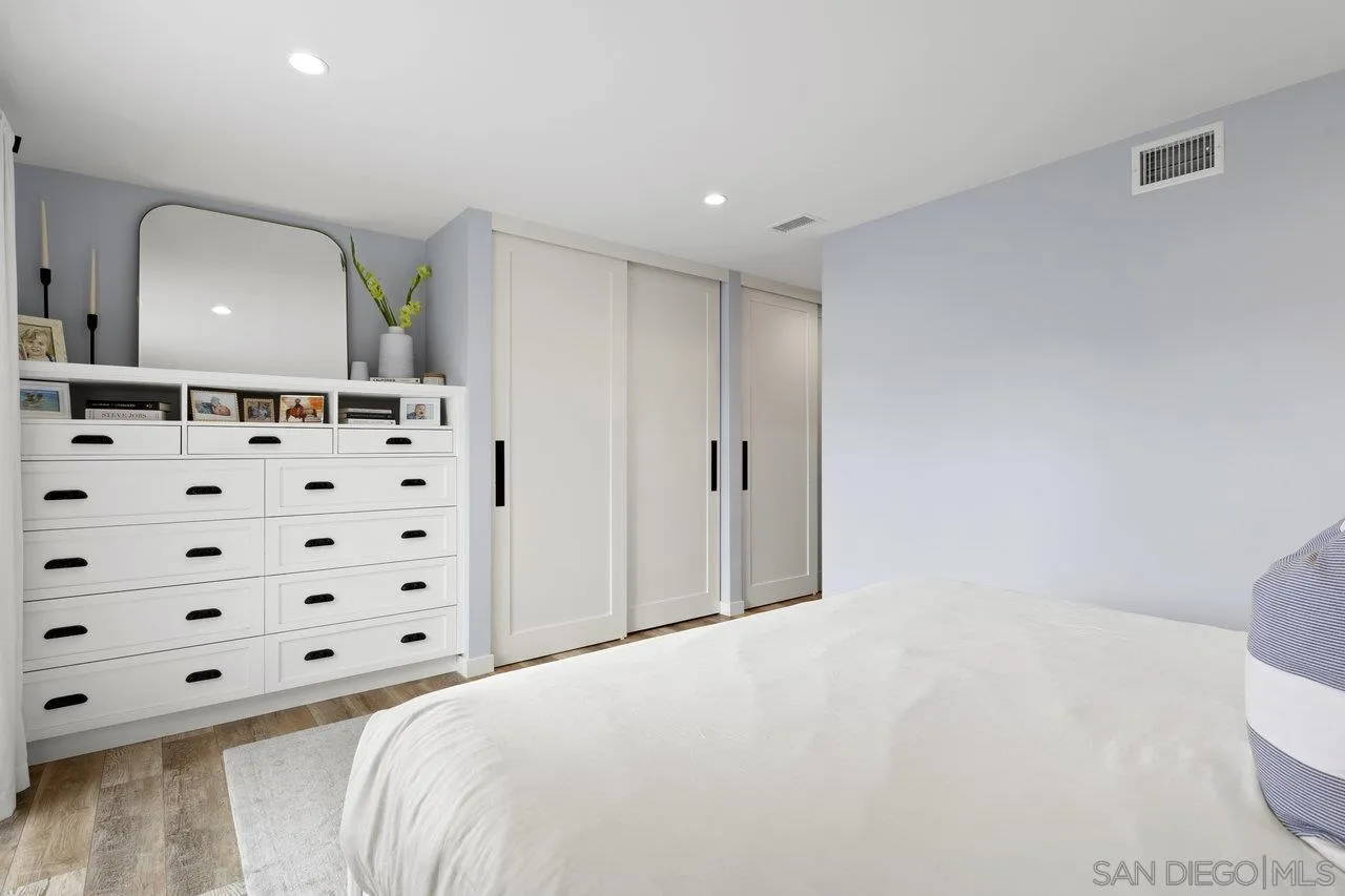 1521 Traske Road Encinitas, CA 92024 - Photo 11 of 23 a bedroom with a bed and a mirror