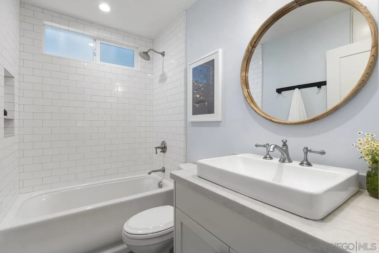 1521 Traske Road Encinitas, CA 92024 - Photo 15 of 23 a bathroom with a sink a toilet and a mirror