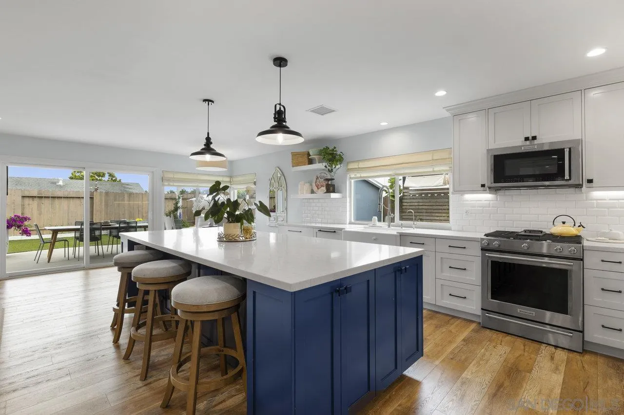 1521 Traske Road Encinitas, CA 92024 - Photo 3 of 23 a kitchen with stainless steel appliances kitchen island granite countertop a stove and a sink