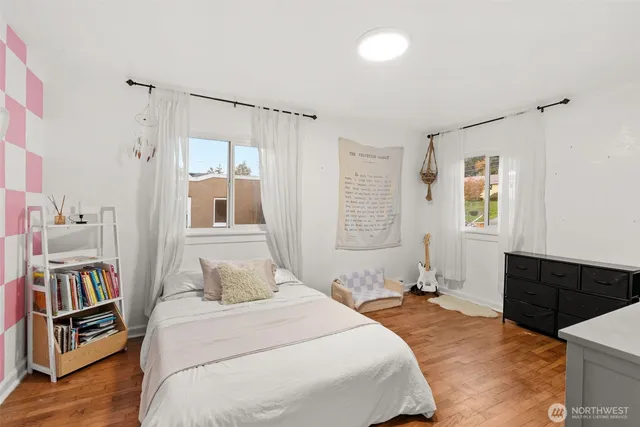 a bedroom with a bed and a dresser in it