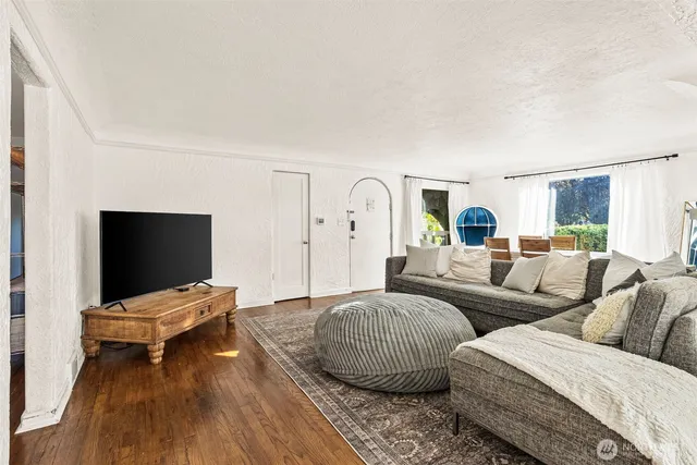 a living room with couches and a flat screen tv
