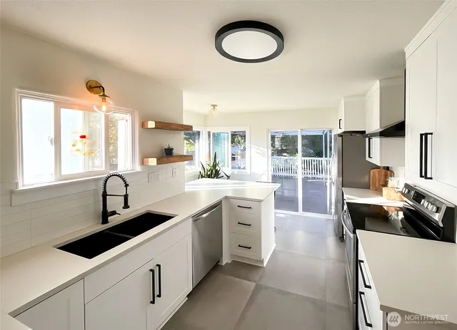 a kitchen with cabinets a sink and appliances