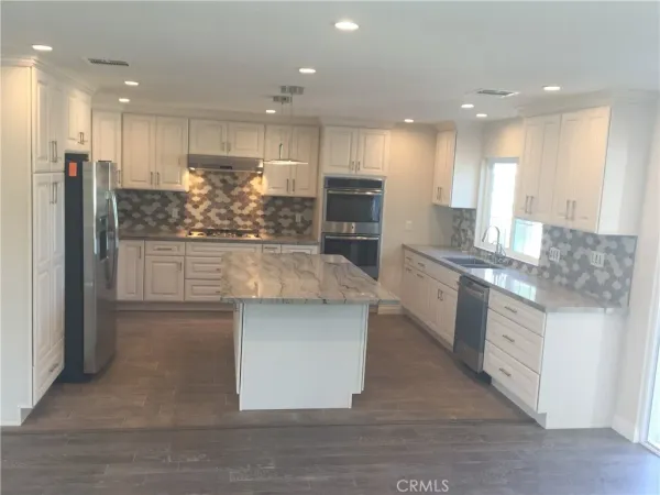 a large kitchen with stainless steel appliances kitchen island granite countertop a large counter top stainless steel appliances and cabinets