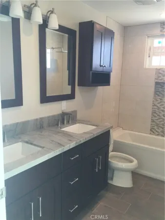 a bathroom with a toilet and a bathtub