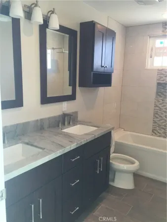 a bathroom with a toilet and a bathtub