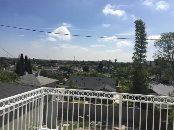 a view of a balcony with wooden fence