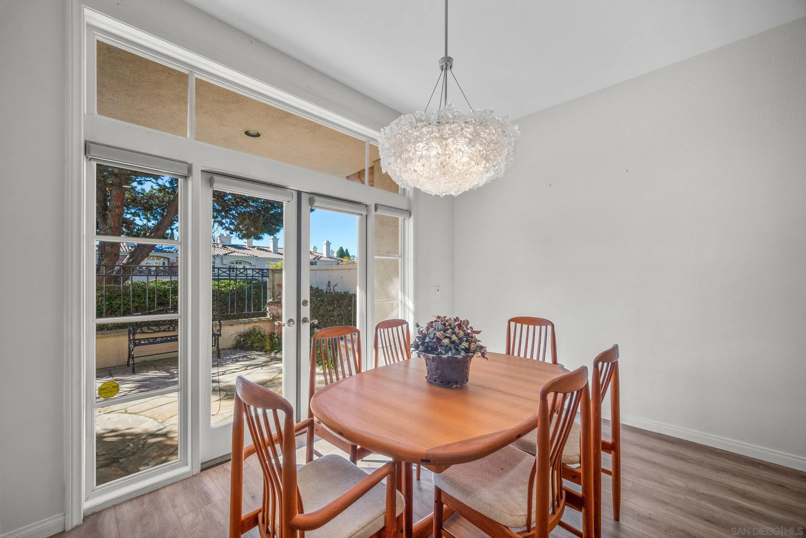 5380 Renaissance Avenue San Diego, CA 92122 - Photo 12 of 25 a view of a dining room with furniture wooden floor and chandelier