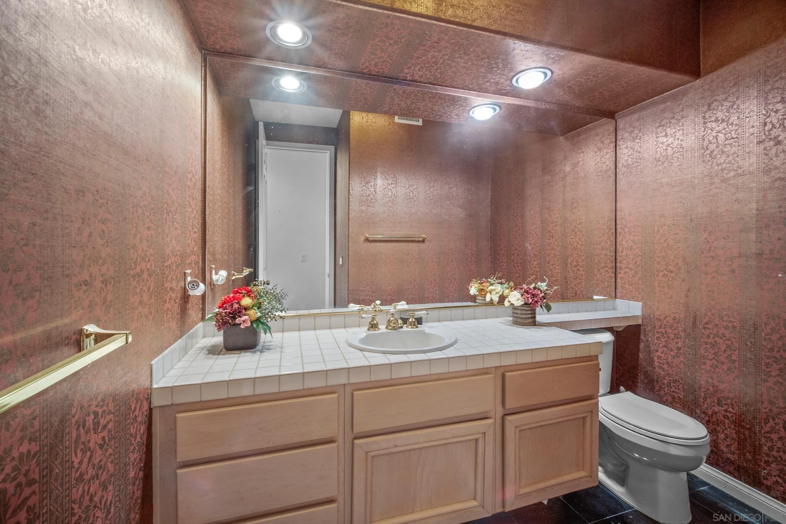 5380 Renaissance Avenue San Diego, CA 92122 - Photo 15 of 25 a bathroom with a sink toilet and mirror