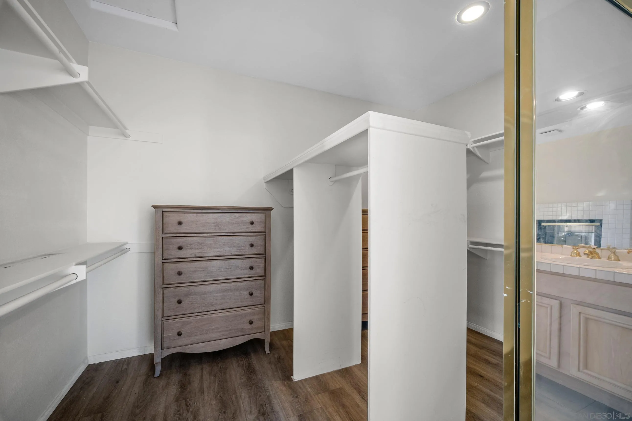 5380 Renaissance Avenue San Diego, CA 92122 - Photo 18 of 25 a view of walk in closet with empty racks