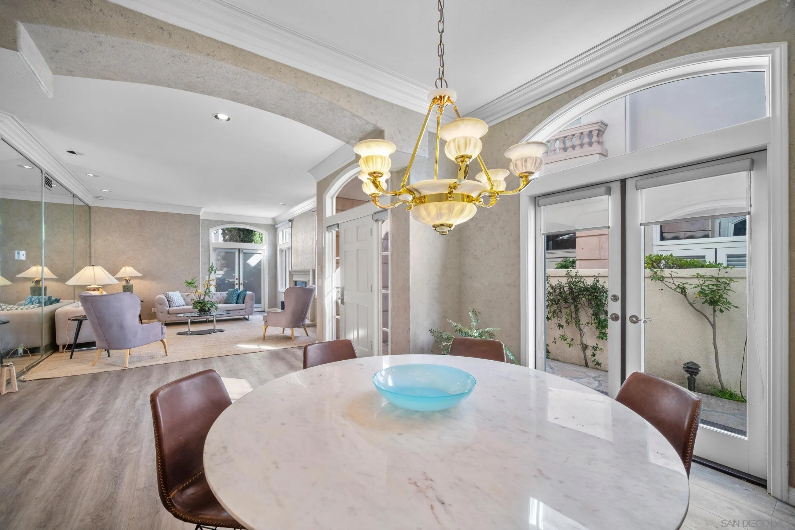 5380 Renaissance Avenue San Diego, CA 92122 - Photo 6 of 25 a living room with dining table and a chandelier