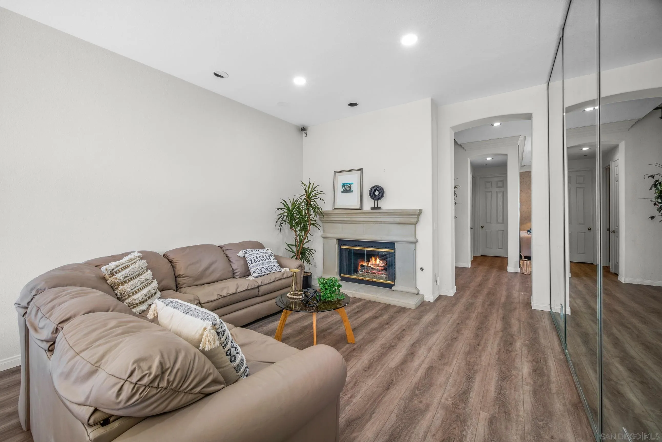 5380 Renaissance Avenue San Diego, CA 92122 - Photo 8 of 25 a living room with furniture and a fireplace